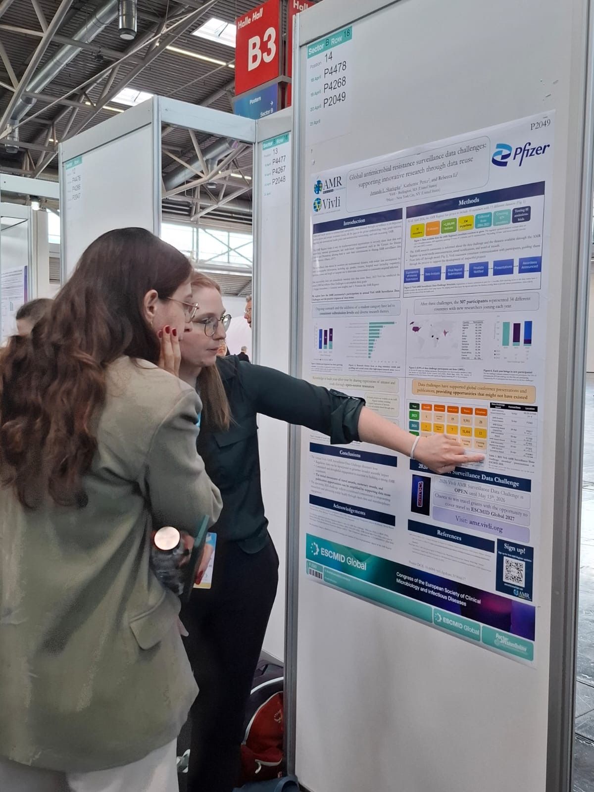 Researchers discussing a poster at ESCMID Global 2026